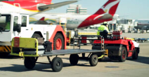 Baggage Handler driving cart Qantas planes